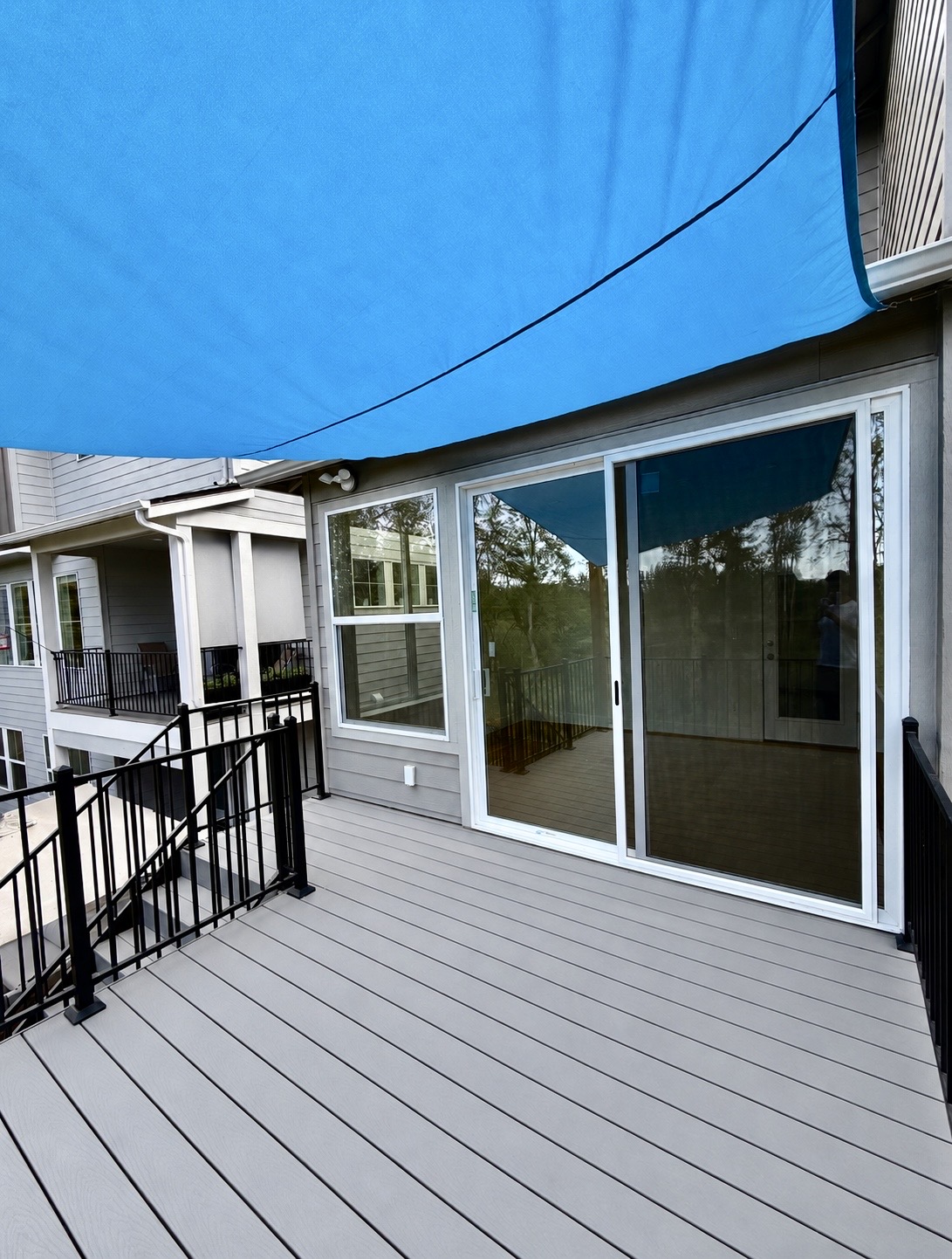 Composite deck at sliding doors, Bethany Finished composite deck off sliding glass doors of new home addition, Bethany Oregon