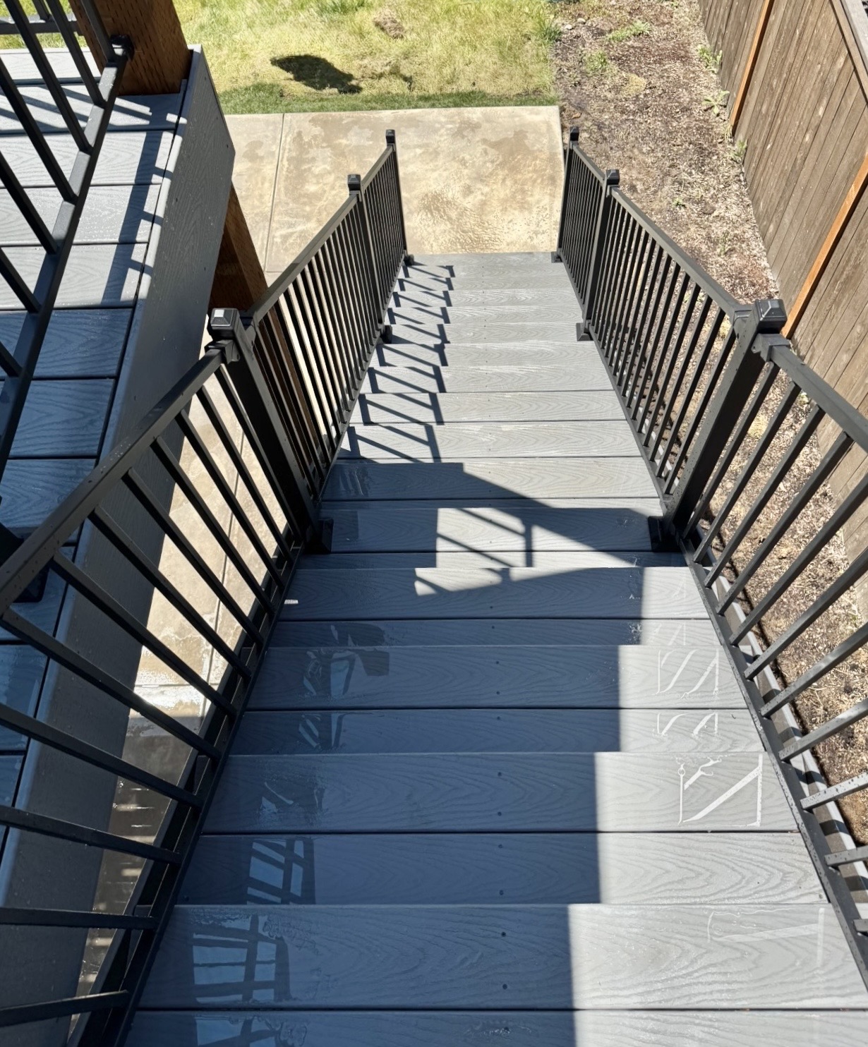Concrete patio with deck stairs, Bethany New concrete patio and deck stairs in Bethany, Oregon — hardscaping by Masters Construction Group