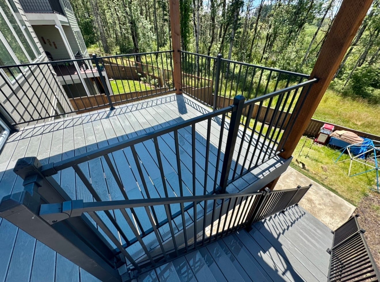 Custom composite deck build in Bethany — upper overlook off new home addition