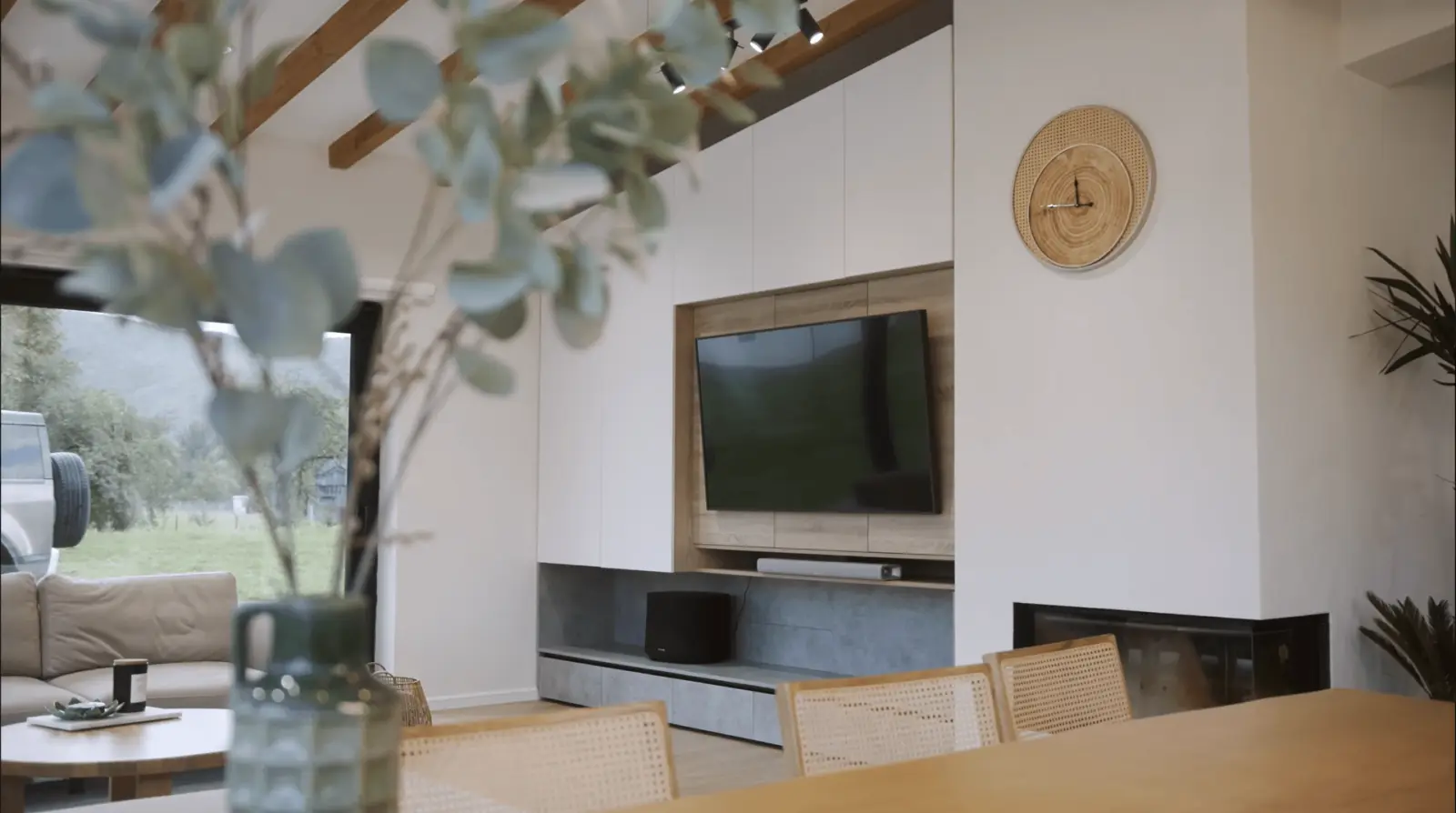 West Linn home remodel — light-filled interior living and dining space with exposed wood beams, custom built-ins, and integrated fireplace by Masters Construction Group